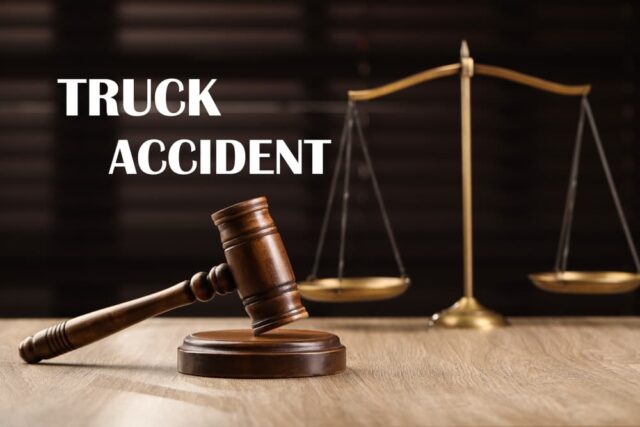 Truck accident law with a wooden judge's gavel and scales of justice on the table.